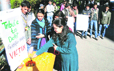 Students pay tribute to the gang rape victim at Himachal Pradesh University in Shimla on Saturday. 