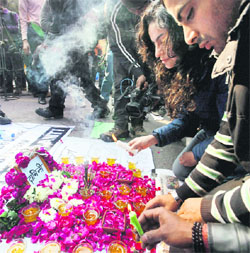 Protesters pay tributes to the gang-rape victim at a makeshift memorial during a demonstration to mourn her death at Jantar Mantar in New Delhi on Saturday.