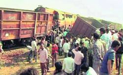 People gather near the accident spot after a collision between a goods train and Hyd-Kholapur Express in Bellary on Saturday.