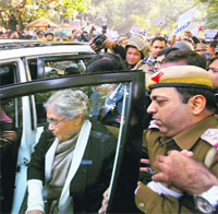 Security personnel escort Delhi Chief Minister Sheila Dikshit as she returns after anti-rape protesters stopped her at Jantar Mantar from taking part in a demonstration to mourn the death of the gang-rape victim, in New Delhi on Saturday.
