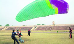 A man learns the basics of paragliding at a stadium in Muktsar.