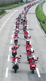 Bikers wearing Santa Claus suits ride their bikes in Belgrade on Saturday. Some 350 bikers brought presents to patients at a children's hospital in Belgrade.