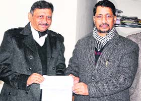 Industry Minister Anil Joshi hands over a cheque of Rs 1.5 crore to the MC Commissioner in Amritsar on Sunday