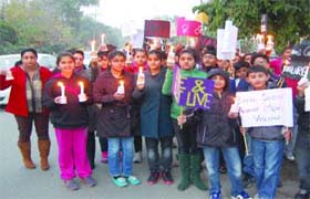 Children, along with their parents, light candles to pay homage to the Delhi gang-rape victim at Amritsar on Sunday