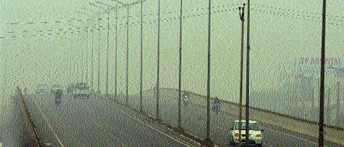 Vehicles move at a snail’s pace during dense fog on the Chandigarh-Delhi National Highway near Zirakpur on Sunday.