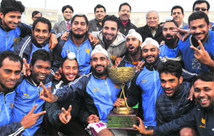 Members of the PNB team pose with their trophy after winning the hockey tournament in Chandigarh.