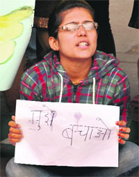A girl takes part in a protest in Sector 17, Chandigarh, on Sunday. 