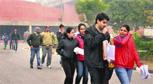 Students come out of an examination centre after appearing for the UGC-NET at Panjab University in Chandigarh on Sunday. 
