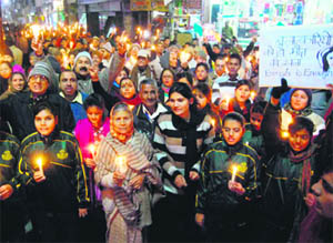 Residents of Kotdwar, Pauri Garhwal, take out a candle march to mourn the death of the Delhi gang rape victim. 