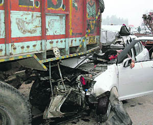 A Swift Dzire car after hitting a truck on the GT Road near Ambala City on Sunday.