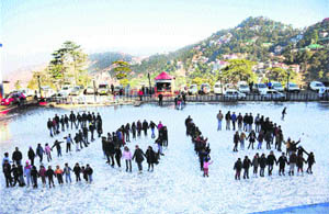 Ice-skaters form a human chain shaped like 2013 as they welcome the New Year at the ice-skating rink in Shimla on Sunday. 