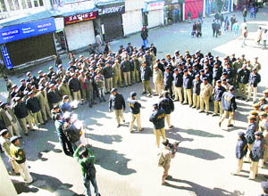 Policemen on duty ahead of New Year Eve celebrations at the Mall in Shimla on Sunday.  