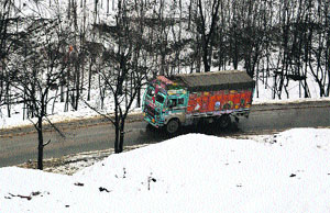 A truck moves towards Jammu near Qazigund, 69 km from Srinagar, on the Jammu-Srinagar National Highway on Sunday.