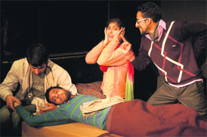 Artiste enact a scene from the play Paanch Futt Ki Shishi at Natrang Studio Theatre in Jammu on Sunday. 