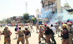 Police try to control an unruly mob during the curfew that was clamped in Gurdaspur in March this year following clashes between Hindu and Sikh fundamentalist organisations. 