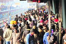 Passengers wait for their trains most of which ran behind schedule due to bad weather at the Ludhiana railway station on Sunday. 