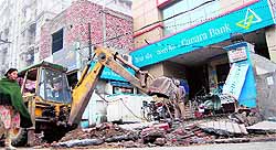 JCB machines of the MC raze encroachments on the Lawrence Road in Amritsar on Monday