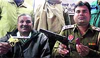 Government Railway Police officials show the seized pistols from a Jalandhar-based resident in Amritsar on Monday