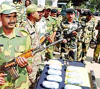 BSF jawans show 9 kg heroin, a carbine magazine along with 18 cartridges and mobile SIM cards seized near Amritsar in October