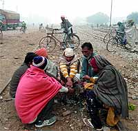 People sit on the railway track in Muktsar unaware of the inherent danger