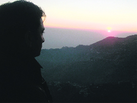 A tourist watches the last sunset of 2012 from Picture Palace in Mussoorie 
