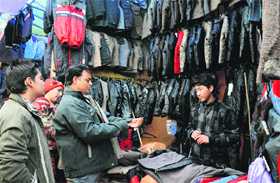 With a cold wave sweeping the region, customers throng a stall to buy winter clothes at the Tibetan Refugee Sweater Bazar in Karnal on Monday. 