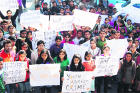 Students of Government College hold a protest rally in memory of the Delhi gang rape victim in Dharamsala on Monday.