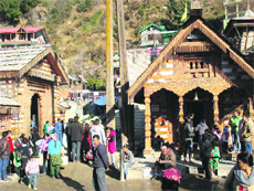 Tourists visit the Vashisht Rishi temple and hot water spring on New Year Eve on Monday.