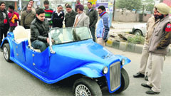DTO Manpreet Chhatwal (wearing a coat) takes a look at a golf cart in the Sarabha Nagar market. Tribune Photo: Himanshu Mahajan.