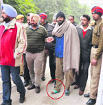 Maninder Pal Singh Johar, alias Sunny Goodwill (centre), being taken to a court in Ludhiana on Monday. photo: Inderjeet Verma 