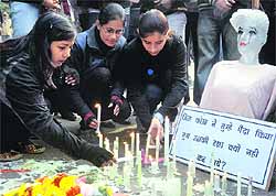 Protesters light candles at Jantar Mantar in New Delhi on Monday