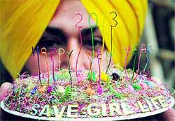 Artist Harwinder Singh displays his new creation with the message to save the girl child, in Amritsar on Monday