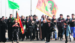 Iraqi Shiite Muslim pilgrims march along the main highway that links Baghdad with Karbala on Monday to take part in the Arbaeen religious festival.  AFP