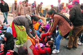 The protesters being forcibly removed from the site of the dharna