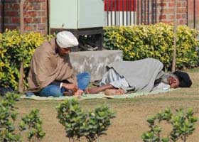 Beating the chill: A youngster and an elderly man enjoy a sunny afternoon in Bathinda on Tuesday