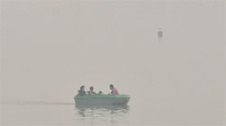 Sukhna Lake covered with a thick blanket of fog; and (below) tourists brave th