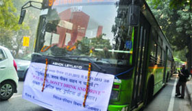 A banner which reads Dont drink and drive hang with a DTC bus during a road safety week campaign in New Delhi on Tuesday.
