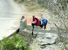 A girl prepares to cross over a stream in an adventure sports camp. Photo by writer