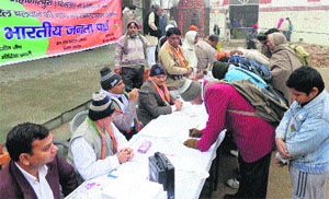 BJP activists obtain signatures of daily commuters for metro service at Sonepat railway station on Tuesday. 