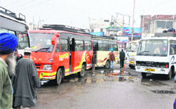 Bus and mini bus drivers stop their vehicles bang in the middle of the road on Day One of Road Safety Week in Jammu on Tuesday. Tribune photo: Anand Sharma