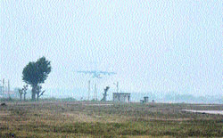 A plane prepares to land in a blanket of fog at an airport in Jammu on Tuesday. Tribune photo: Anand Sharma