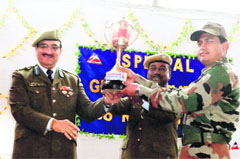 Project Sampark chief engineer UC Mehta gives a trophy to an official in Jammu on Tuesday. A Tribune photograph