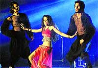 A dancer and her troupe perform a belly dance