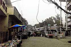 An electric wire hangs in the middle of a market in Nakodar on Tuesday
