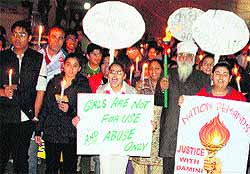 Members of the Samvedna Trust and Shri Durga Mandir Trust during the candle march at College road in Ludhiana on Tuesday