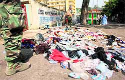 Clothing and various items scattered over the pavement at the scene following a stampede in Abidjan on Tuesday