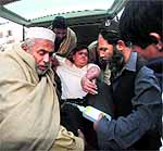 An injured driver (in white) who survived the shooting in Swabi in Peshawar on Tuesday
