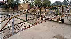 The wooden-cum-iron bridge over the lake is also in a poor shape