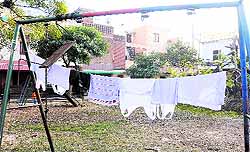 Clothes drying on a broken swing at a park in Sector 45-D