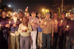 Newspaper hawkers hold a candle march in support of the demand for justice for the Delhi rape victim in Haridwar on Wednesday; and (below) women light candles at a statue of Shaheed Bhagat Singh to show their solidarity. Tribune photos: Rameshwar Gaur